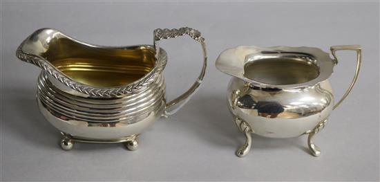 An early 19th century silver cream jug, marks rubbed, circa 1830 and a 20th century silver cream jug,